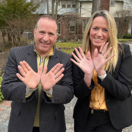 Kathryn and Scott showing hope sign