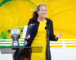 woman in yellow dress giving speech