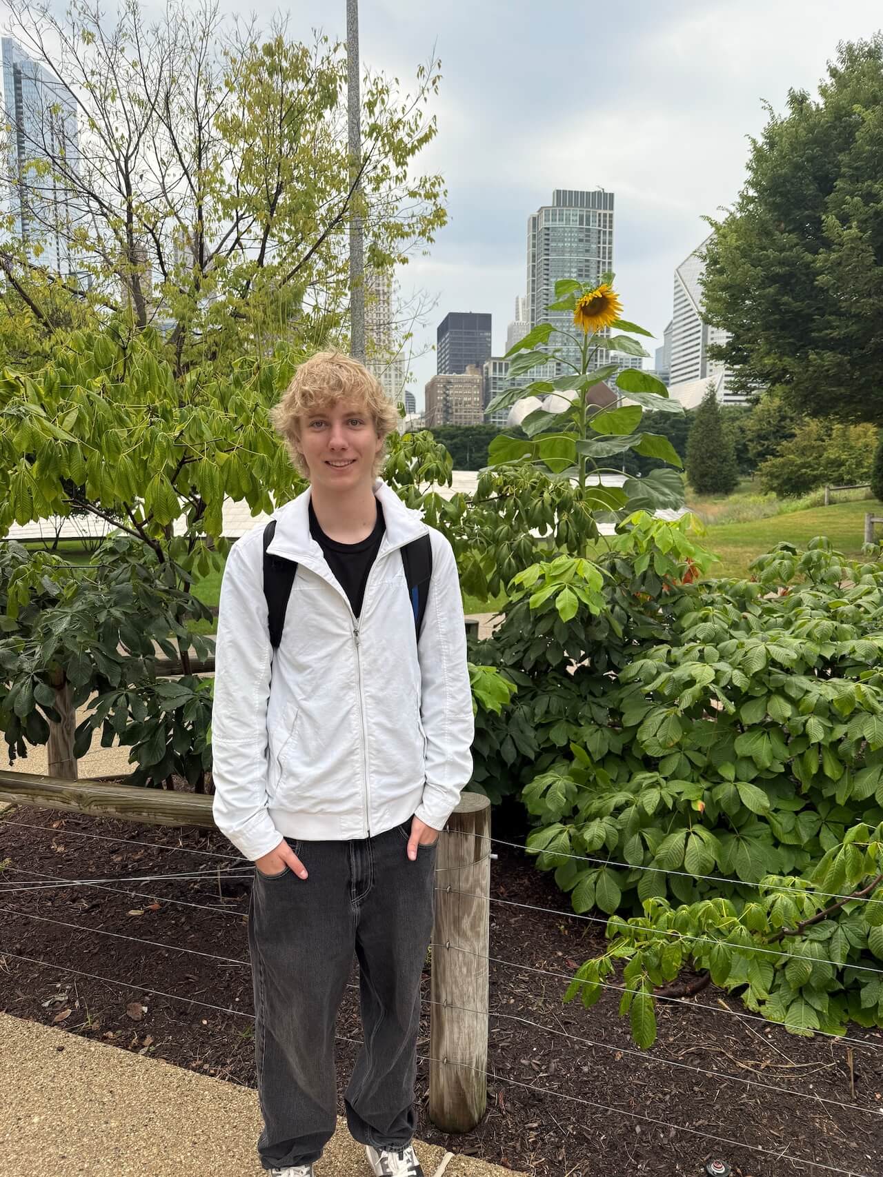 Julian beside sunflower at Maggie Daley Park